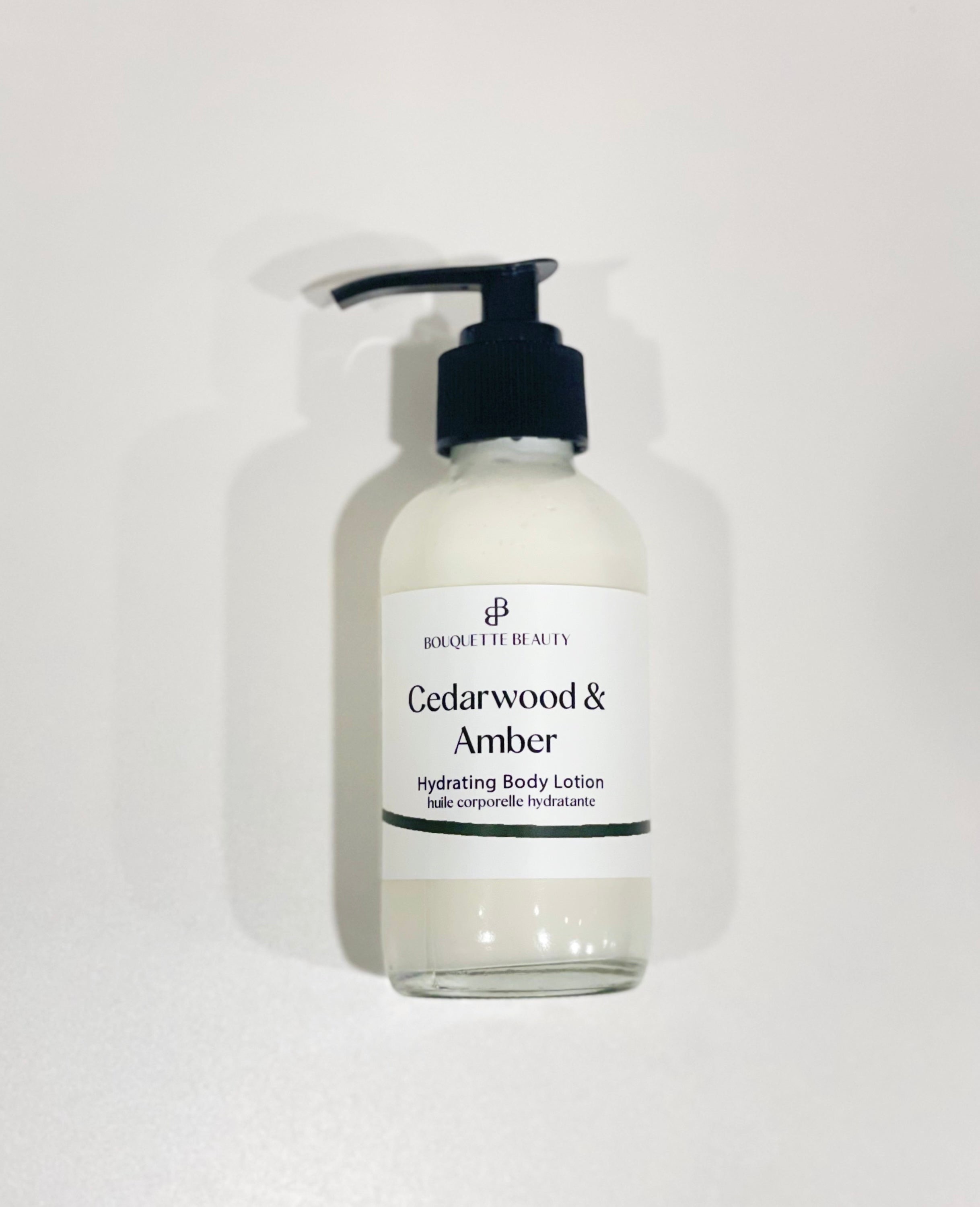 Raw Cedarwood & Amber body lotion bottle on a plain white background