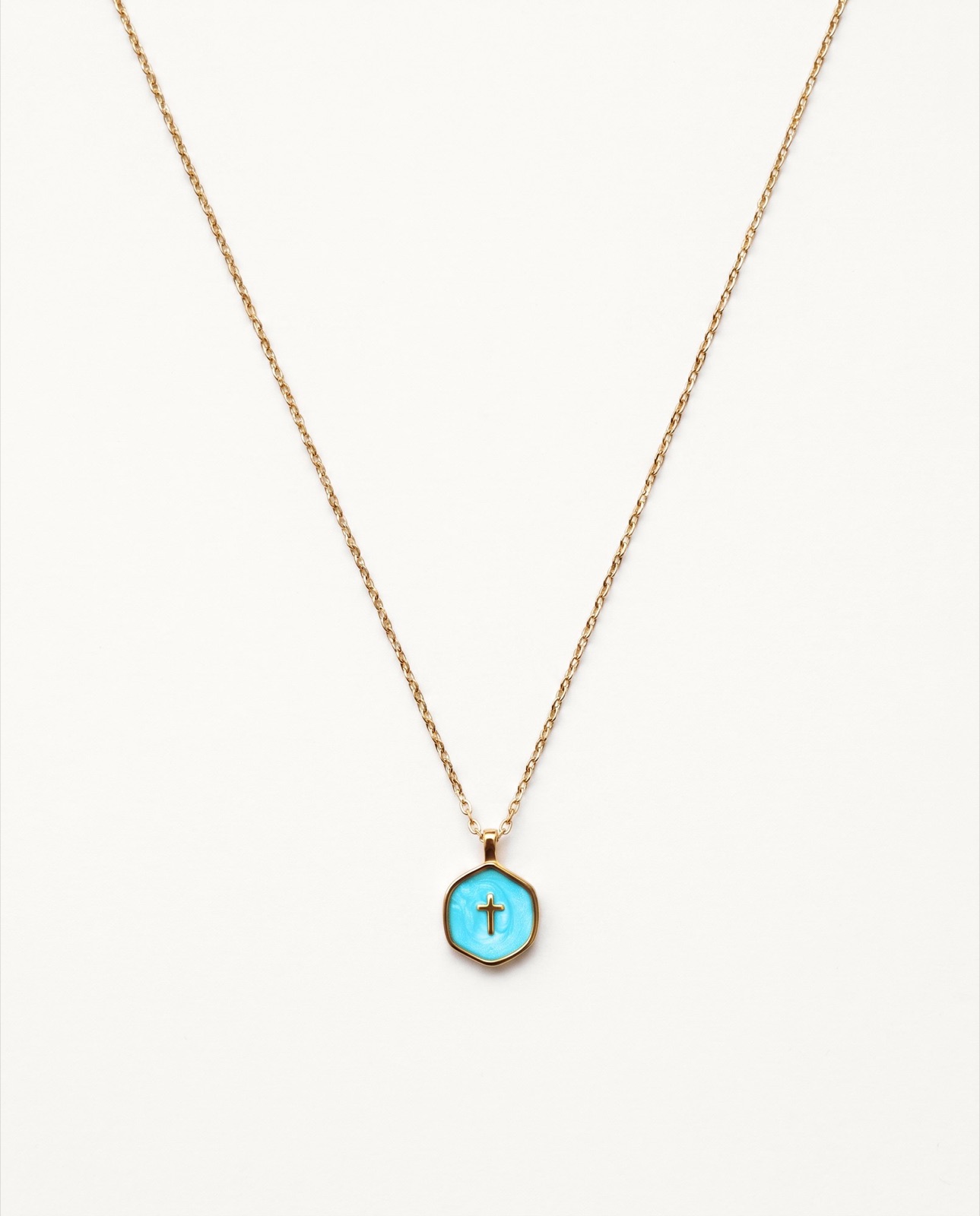 Gold pendant necklace pack shot on a plain background